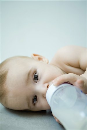Baby lying down, drinking from bottle Stock Photo - Premium Royalty-Free, Code: 695-05766782