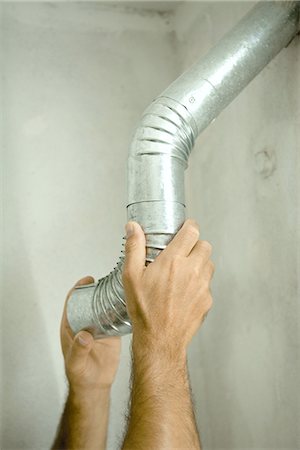 Man adjusting air duct, close-up of hands Stock Photo - Premium Royalty-Free, Code: 695-05766802