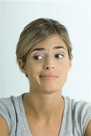 smirk - Woman making face, portrait Stock Photo - Premium Royalty-Free, Code: 695-05766903