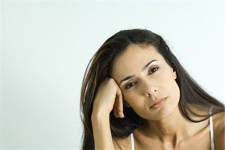 dissatisfied - Woman leaning on hand, looking at camera, portrait Stock Photo - Premium Royalty-Free, Code: 695-05766913