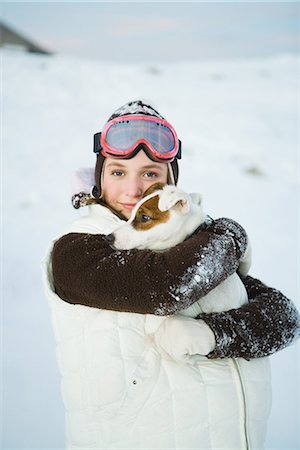 fleece - Teenage girl embracing dog, dressed in winter clothing, smiling at camera, portrait Stock Photo - Premium Royalty-Free, Code: 695-05766987