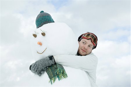 snow cone - Bonhomme de neige hugging jeune homme Photographie de stock - Premium Libres de Droits, Code: 695-05767119