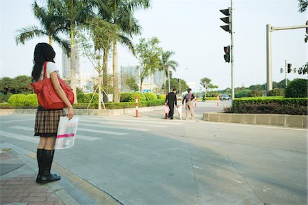 people crossing crosswalk - Young woman waiting to cross street Stock Photo - Premium Royalty-Free, Code: 695-05767126