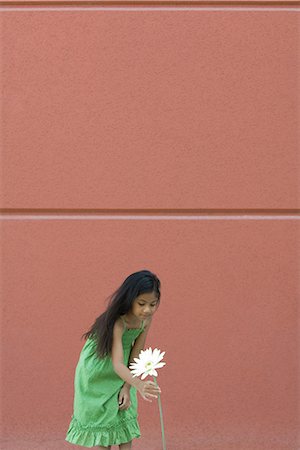 flower bending over - Girl bending over to pick tall flower Stock Photo - Premium Royalty-Free, Code: 695-05767187