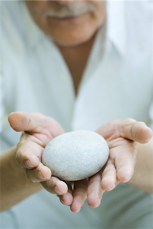 simsearch:633-02231743,k - Hands holding out round pebble Stock Photo - Premium Royalty-Free, Code: 695-05767193