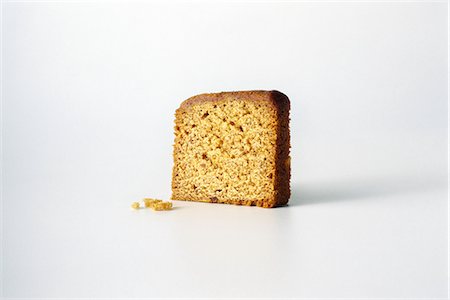 Slice of bread and crumbs, white background Foto de stock - Sin royalties Premium, Código: 695-05767613