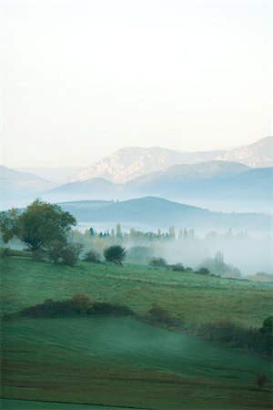 prairie nobody - Rolling landscape with mist, mountains in the distance Stock Photo - Premium Royalty-Free, Code: 695-05767640