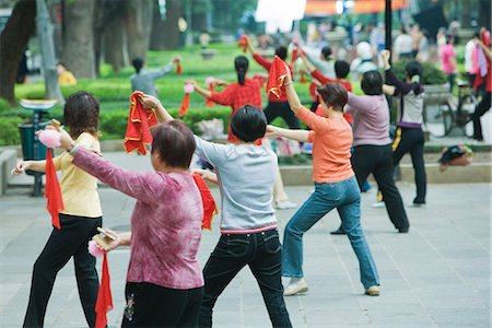 China, Guangzhou, group of woman practicing tai chi chuan outdoors, rear view Stock Photo - Premium Royalty-Free, Code: 695-05767651