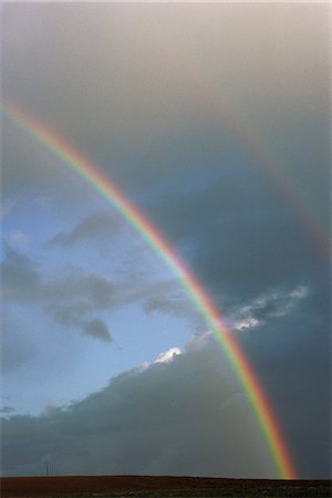 Two rainbows and cloudy sky over rural field Stock Photo - Premium Royalty-Free, Code: 695-05767707