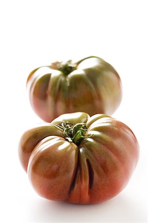 Two heirloom tomatoes, close-up Stock Photo - Premium Royalty-Free, Code: 695-05767753