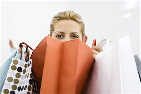 shopping bag closeup - Woman looking over several shopping bags Stock Photo - Premium Royalty-Free, Code: 695-05767935