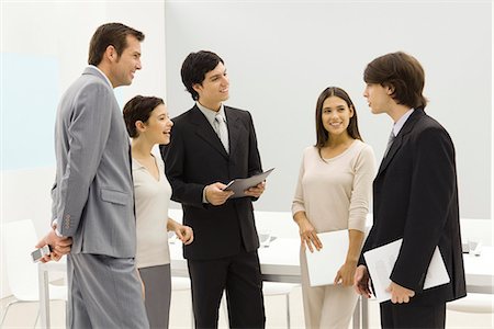 simsearch:695-03380508,k - Group of business associates standing together, smiling, chatting Stock Photo - Premium Royalty-Free, Code: 695-05768200