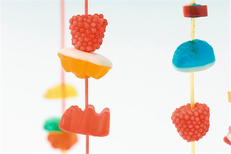 false - Colorful candy hanging on strings, close-up Stock Photo - Premium Royalty-Free, Code: 695-05768211