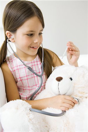 simsearch:614-09212260,k - Little girl listening to teddy's bear's heart with stethoscope, looking at thermometer Stock Photo - Premium Royalty-Free, Code: 695-05768236