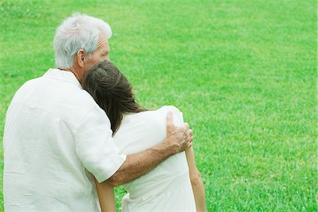 Teen girl leaning head on grandfather's shoulder, rear view Stock Photo - Premium Royalty-Free, Code: 695-05768357