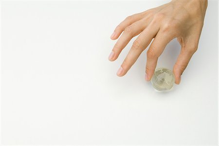 finger white background - Hand holding tiny globe, cropped view Stock Photo - Premium Royalty-Free, Code: 695-05768472