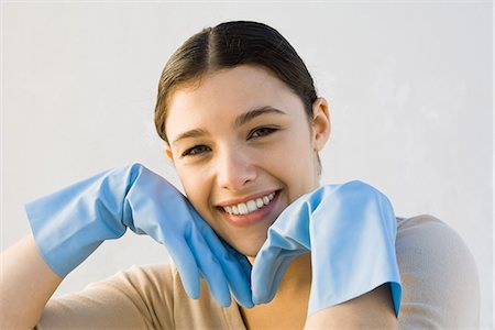 female latex gloves - Young woman wearing rubber gloves, smiling at camera, hands under chin Stock Photo - Premium Royalty-Free, Code: 695-05768537