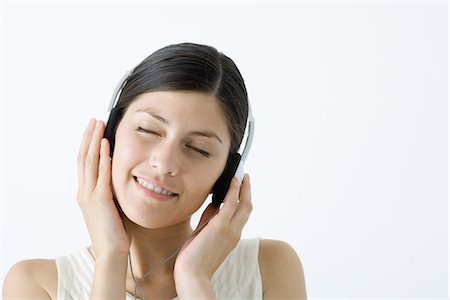 simsearch:633-02128680,k - Young woman listening to headphones, smiling, eyes closed Stock Photo - Premium Royalty-Free, Code: 695-05768634