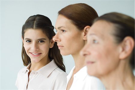 simsearch:614-02680369,k - Three generations of women, focus on teen girl smiling at camera Stock Photo - Premium Royalty-Free, Code: 695-05768696