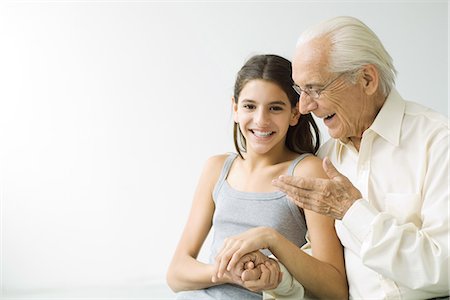 silhouettes cheerful people - Grandfather and teen granddaughter holding hands, laughing Stock Photo - Premium Royalty-Free, Code: 695-05768692