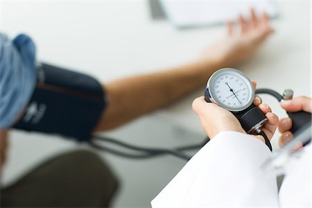 Doctor measuring patient's blood pressure, cropped view Stock Photo - Premium Royalty-Free, Code: 695-05768766