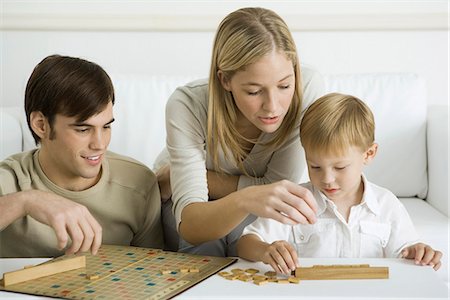 scatter - Family playing board game together Stock Photo - Premium Royalty-Free, Code: 695-05768885
