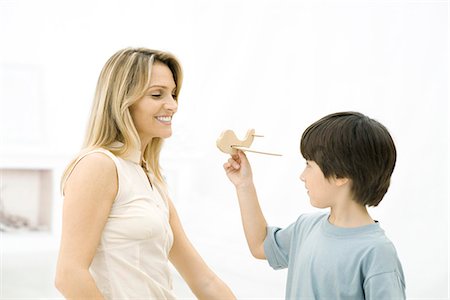 Boy showing his mother toy airplane, side view Stock Photo - Premium Royalty-Free, Code: 695-05768889