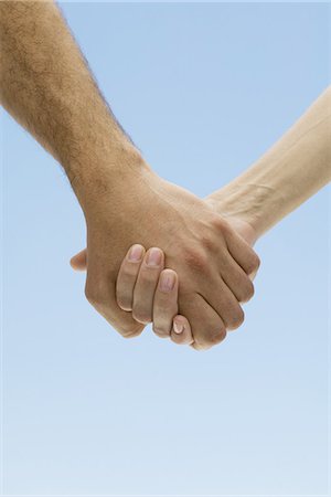 Couple holding hands, cropped view Stock Photo - Premium Royalty-Free, Code: 695-05768937