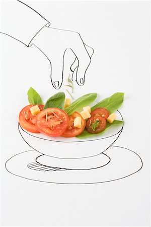 Drawing of hand sprinkling seasonings on salad Stock Photo - Premium Royalty-Free, Code: 695-05768977