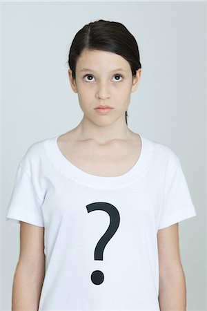 puzzled person white background - Preteen girl wearing tee-shirt printed with question mark, looking up, portrait Stock Photo - Premium Royalty-Free, Code: 695-05768987