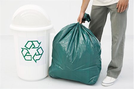 people holding garbage bags - Man holding large garbage bag next to recycling bin, cropped view Stock Photo - Premium Royalty-Free, Code: 695-05769222