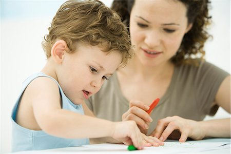 Mother and son sitting together, coloring with crayons Stock Photo - Premium Royalty-Free, Code: 695-05769245