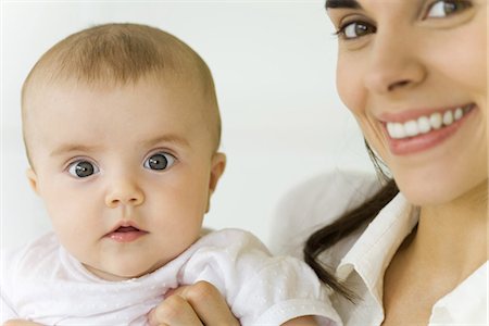 simsearch:695-03380144,k - Mother holding baby, smiling at camera Stock Photo - Premium Royalty-Free, Code: 695-05769251