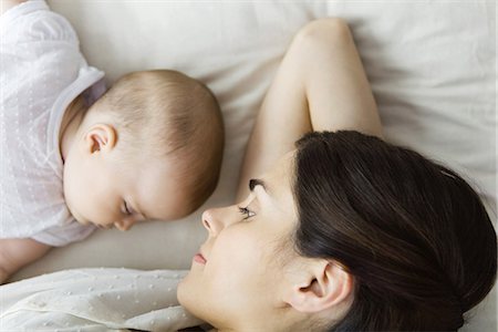 Mother watching baby napping, lying together on bed Stock Photo - Premium Royalty-Free, Code: 695-05769253