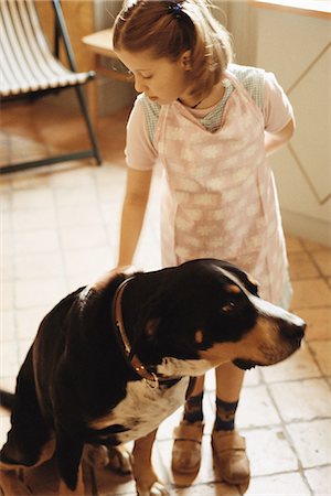 Girl petting dog Stock Photo - Premium Royalty-Free, Code: 695-05769304