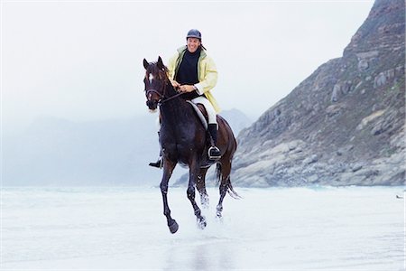 riding on horses on the beach - Man riding horse on beach Stock Photo - Premium Royalty-Free, Code: 695-05769427