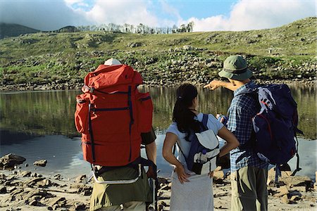 Hikers deciding how to cross pond, rear view Stock Photo - Premium Royalty-Free, Code: 695-05769436