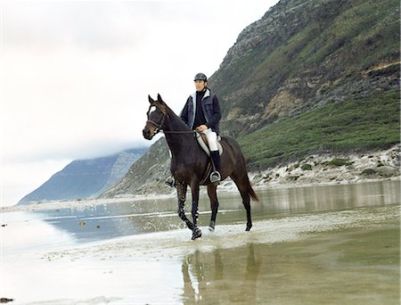 Man riding horse through water Stock Photo - Premium Royalty-Free, Code: 695-05769444