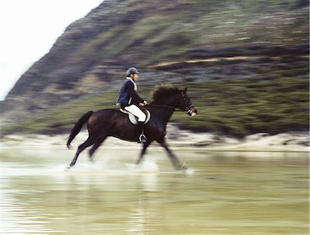 Man riding horse through water, blurred motion Stock Photo - Premium Royalty-Free, Code: 695-05769445