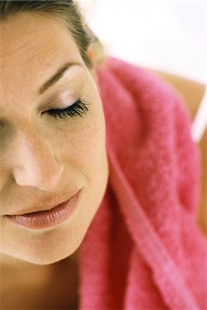 Woman with eyes closed, towel on shoulder Stock Photo - Premium Royalty-Free, Code: 695-05769639