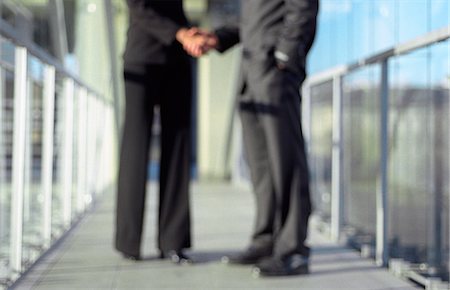 Professionals shaking hands, blurred, low section Stock Photo - Premium Royalty-Free, Code: 695-05769648
