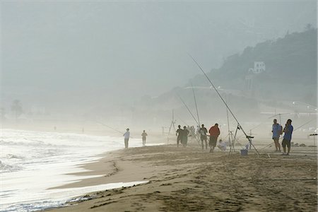 Group of people fishing on foggy beach Stock Photo - Premium Royalty-Free, Code: 695-05769687