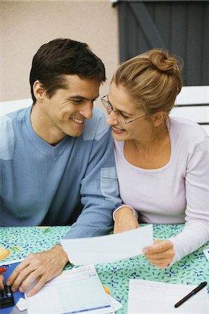 Couple sitting at table, discussing finances Stock Photo - Premium Royalty-Free, Code: 695-05769704