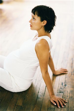 short haired women pregnant - Pregnant woman doing breathing excercise on floor Stock Photo - Premium Royalty-Free, Code: 695-05769767