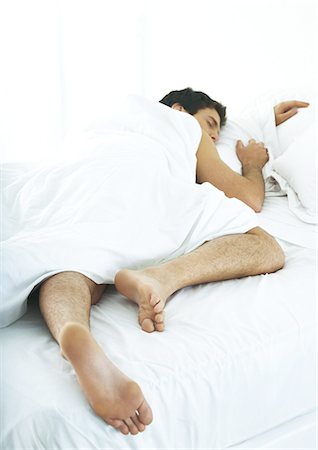 sleeping bed full body - Man sleeping on stomach in bed Stock Photo - Premium Royalty-Free, Code: 695-05762197