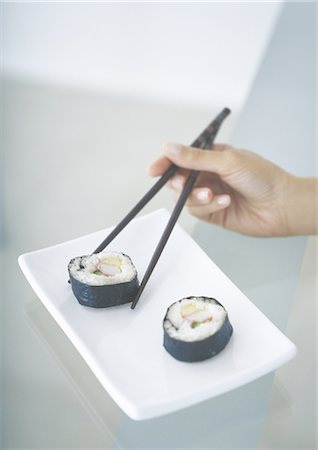 Picking up sushi with chopsticks Stock Photo - Premium Royalty-Free, Code: 695-05762204