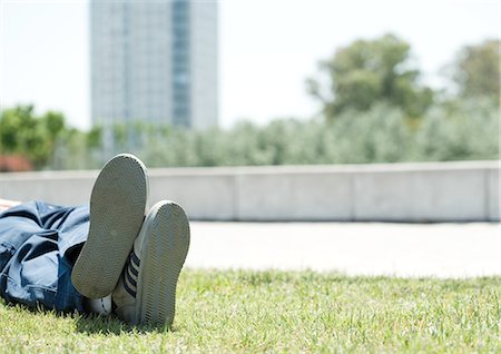 sole of shoe - Man lying on grass in city park Stock Photo - Premium Royalty-Free, Code: 695-05762216