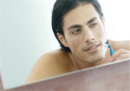 simsearch:632-01154783,k - Man shaving face in mirror Stock Photo - Premium Royalty-Free, Code: 695-05762387