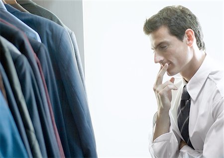 simsearch:400-08031960,k - Man choosing jacket from closet Stock Photo - Premium Royalty-Free, Code: 695-05762401