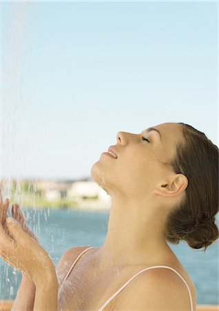Woman showering off outside Stock Photo - Premium Royalty-Free, Code: 695-05762417